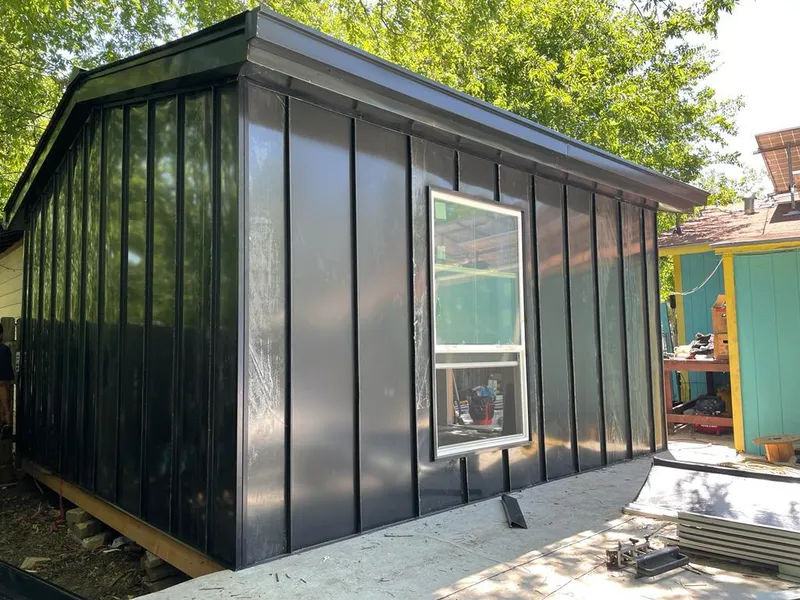 Black standing seam metal wall panels for Roof Inspection in Paola